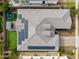 Aerial view of the roof with solar panels and a backyard with artificial turf, hot tub, and trampoline at 14845 W Georgia Dr, Surprise, AZ 85379