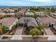 A charming home with well-kept landscaping and a paver driveway, surrounded by similar homes in the neighborhood at 14845 W Georgia Dr, Surprise, AZ 85379