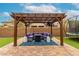 Inviting backyard oasis featuring a covered patio, comfortable seating, and a trampoline for outdoor enjoyment at 14845 W Georgia Dr, Surprise, AZ 85379