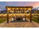 Charming backyard with a pergola, comfortable seating, and ambient string lights, perfect for outdoor entertaining at 14845 W Georgia Dr, Surprise, AZ 85379