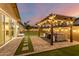 Beautiful backyard with a covered patio, lush lawn, and mature palm trees for relaxing outdoor experience at 14845 W Georgia Dr, Surprise, AZ 85379