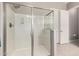 Bright bathroom featuring a glass enclosed shower with silver hardware and tile floors at 14845 W Georgia Dr, Surprise, AZ 85379