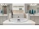 Luxurious bathroom with a soaking tub, dual vanities, and serene decor at 14845 W Georgia Dr, Surprise, AZ 85379