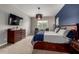 Spacious primary bedroom with decorative lighting, comfortable bed, dresser, and cozy seating area at 14845 W Georgia Dr, Surprise, AZ 85379