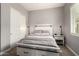 Cozy bedroom featuring a queen bed, stylish lamps, closet and a window at 14845 W Georgia Dr, Surprise, AZ 85379