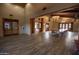Spacious community room with wood floors, large tables, and a neutral color palette at 14845 W Georgia Dr, Surprise, AZ 85379