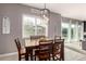 Cozy dining area with a window view and modern chandelier lighting at 14845 W Georgia Dr, Surprise, AZ 85379