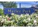 Marley Park community entrance sign surrounded by flowering bushes and a wrought iron fence at 14845 W Georgia Dr, Surprise, AZ 85379