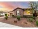 Attractive exterior featuring stone accents, a charming facade, and a well-maintained front yard at 14845 W Georgia Dr, Surprise, AZ 85379