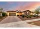 Beautiful home featuring stone and stucco exterior, two-car garage, and lush landscaping at 14845 W Georgia Dr, Surprise, AZ 85379