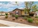 Inviting home featuring stone accents, a charming facade, and a well-maintained front yard at 14845 W Georgia Dr, Surprise, AZ 85379