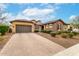 Inviting home showcasing well-kept landscaping, a two-car garage, and a charming facade at 14845 W Georgia Dr, Surprise, AZ 85379