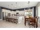 Well-lit kitchen with large island, stainless steel appliances, and dining area at 14845 W Georgia Dr, Surprise, AZ 85379