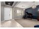Elegant living room features modern lighting, high ceilings, and a grand piano at 14845 W Georgia Dr, Surprise, AZ 85379