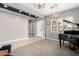 Spacious living room with large windows, a grand piano, and neutral color palette at 14845 W Georgia Dr, Surprise, AZ 85379