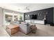 Cozy living room with plush gray seating and an entertainment center with a large-screen TV at 14845 W Georgia Dr, Surprise, AZ 85379
