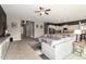 Open-plan living area with stylish seating, view of a modern kitchen, and plenty of natural light at 14845 W Georgia Dr, Surprise, AZ 85379