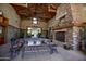 Inviting lounge space featuring a high ceiling, stone fireplace, and ample seating arrangements at 14845 W Georgia Dr, Surprise, AZ 85379