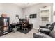 Spacious office featuring a leather chair, a large desk, and comfortable seating at 14845 W Georgia Dr, Surprise, AZ 85379