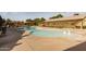 Community pool featuring lounge chairs, shaded pergolas, and clear blue water on a sunny day at 14845 W Georgia Dr, Surprise, AZ 85379