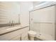 A contemporary bathroom with modern vanity, a walk-in glass shower and bright lighting at 15053 W Gray Fox Trl, Surprise, AZ 85387
