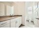 Bright bathroom with quartz countertops, sleek vanity and wood-look tile at 15053 W Gray Fox Trl, Surprise, AZ 85387