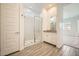 Bright bathroom with a glass shower, modern vanity and gray-toned tile flooring at 15053 W Gray Fox Trl, Surprise, AZ 85387