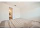 Spacious carpeted bedroom with neutral walls, awaiting personalization and offering a comfortable ambiance at 15053 W Gray Fox Trl, Surprise, AZ 85387