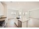 An open kitchen with an island, modern appliances, and a sink, flowing into an open floor plan layout at 15053 W Gray Fox Trl, Surprise, AZ 85387