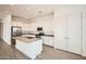 An island kitchen with stainless steel appliances, a sink, and plenty of storage with white cabinetry at 15053 W Gray Fox Trl, Surprise, AZ 85387