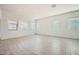 Bright, airy living room featuring tile floors, neutral walls, and abundant natural light from large windows at 15053 W Gray Fox Trl, Surprise, AZ 85387