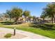 Beautiful community pool area with lush landscaping and plenty of seating for residents at 15240 N 142Nd Ave # 1101, Surprise, AZ 85379