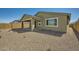 Backyard view showcasing the covered patio and low maintenance landscaping at 15818 W Kendall St, Goodyear, AZ 85338