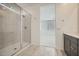 Bathroom with large glass enclosed shower with marble tiling at 15818 W Kendall St, Goodyear, AZ 85338