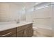 Bathroom featuring white quartz counters, tile floors, and tub with shower at 15818 W Kendall St, Goodyear, AZ 85338