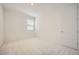 A bedroom with neutral carpet and walls at 15818 W Kendall St, Goodyear, AZ 85338