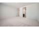 A spacious bedroom with neutral carpet and paint provides a blank canvas at 15818 W Kendall St, Goodyear, AZ 85338