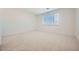 Neutral bedroom with plush carpet, window, and ample natural light at 15818 W Kendall St, Goodyear, AZ 85338