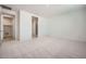 Bright bedroom with neutral carpet and access to laundry area and walk-in closet at 15818 W Kendall St, Goodyear, AZ 85338