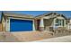 Charming single-story home with a brick driveway, two-car garage, and professionally landscaped front yard at 15818 W Kendall St, Goodyear, AZ 85338