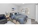 Modern bedroom features an arched window, a queen bed, a gray chair and gray and white decor at 16224 S 40Th Pl, Phoenix, AZ 85048