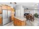 Kitchen island with wood cabinets and stainless steel refrigerator at 16224 S 40Th Pl, Phoenix, AZ 85048