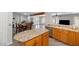 Modern kitchen with island and stainless steel dishwasher, open to living area at 16224 S 40Th Pl, Phoenix, AZ 85048