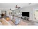 Spacious living room featuring wood floors, ceiling fans and large windows overlooking the pool at 16224 S 40Th Pl, Phoenix, AZ 85048