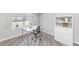 Bright, modern office with a large window, white desk, rolling chair and white storage shelves at 16224 S 40Th Pl, Phoenix, AZ 85048