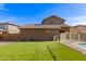 Well-maintained backyard with lush green grass, secure fencing, and mature trees at 16510 W Tether Trl, Surprise, AZ 85387