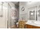This bathroom offers a walk-in shower, a neutral color scheme, and a rustic vanity at 16510 W Tether Trl, Surprise, AZ 85387