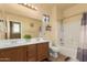 Well-lit bathroom featuring double sinks, a large mirror, a shower-tub combo, and a neutral color scheme at 16510 W Tether Trl, Surprise, AZ 85387