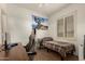 This bedroom is well-lit with a twin bed, a spacious desk, and neutral decor for comfortable living at 16510 W Tether Trl, Surprise, AZ 85387