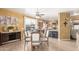 Cozy dining room adjacent to an open concept kitchen with wood-look tile flooring at 16510 W Tether Trl, Surprise, AZ 85387